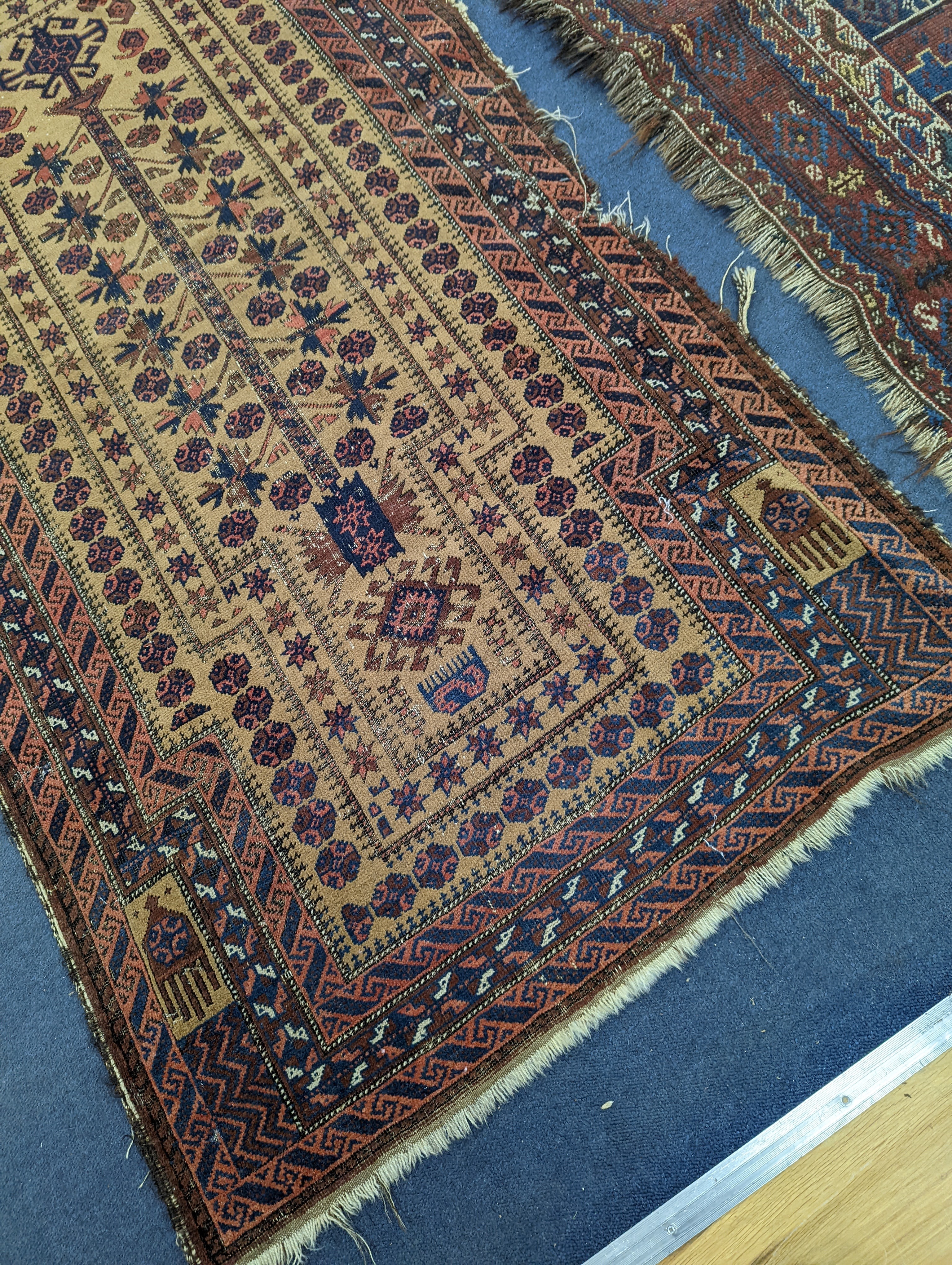 A Caucasian red ground rug and a Belouch rug, larger 200 x 165cm